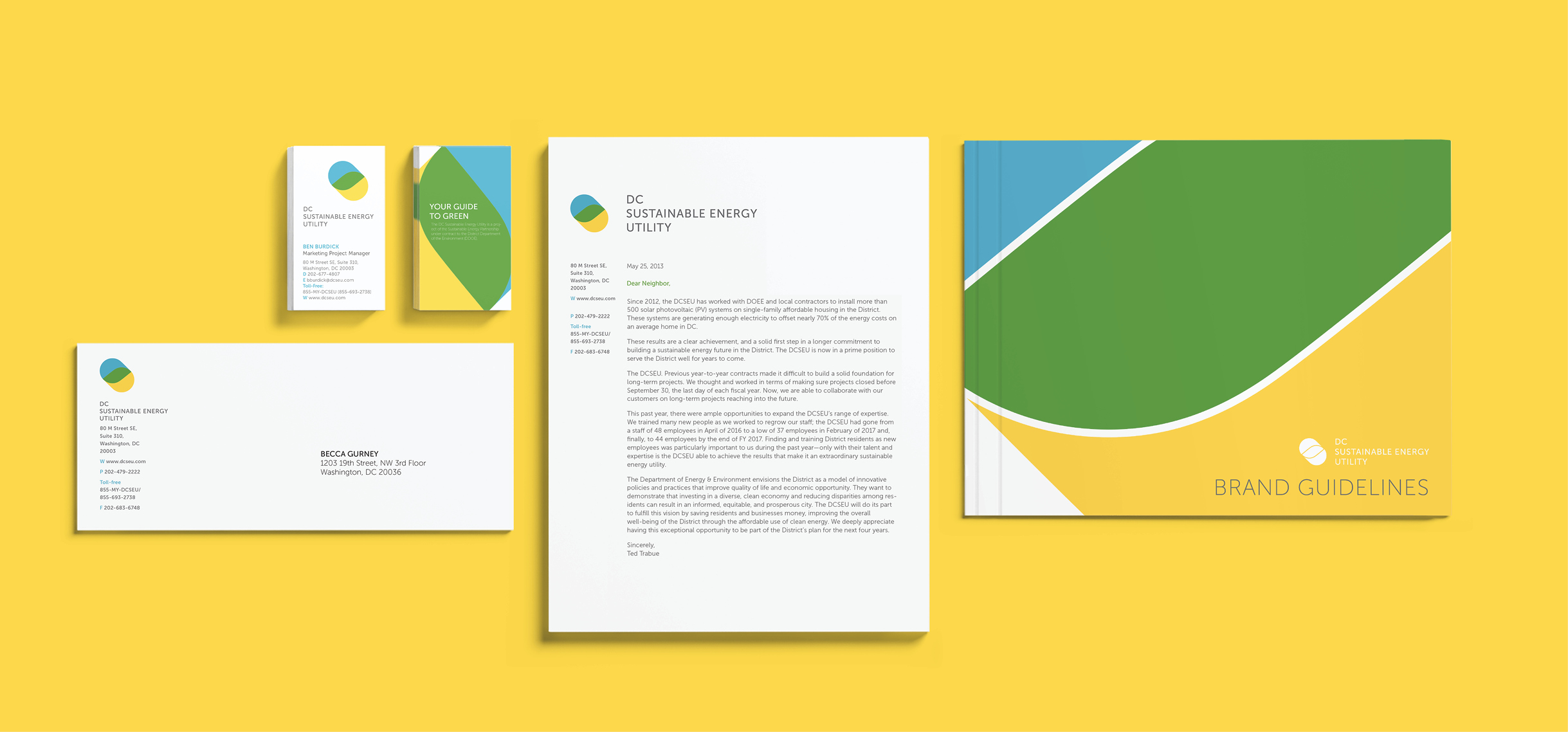 The stationary set including letterhead, business card, envelope and the Brand Guide book. All items are neatly arranged and aligned on a yellow background.