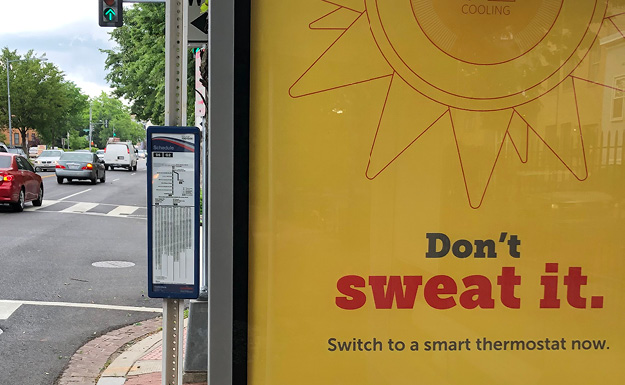 Design Choice are marketing campaign art directors and designers: Closeup of bushelter ad with the tagline Don't Sweat It, Switch to a Smartthermostat now. The ad is yellow with a red type and a red line illustration of a sun/thermostat