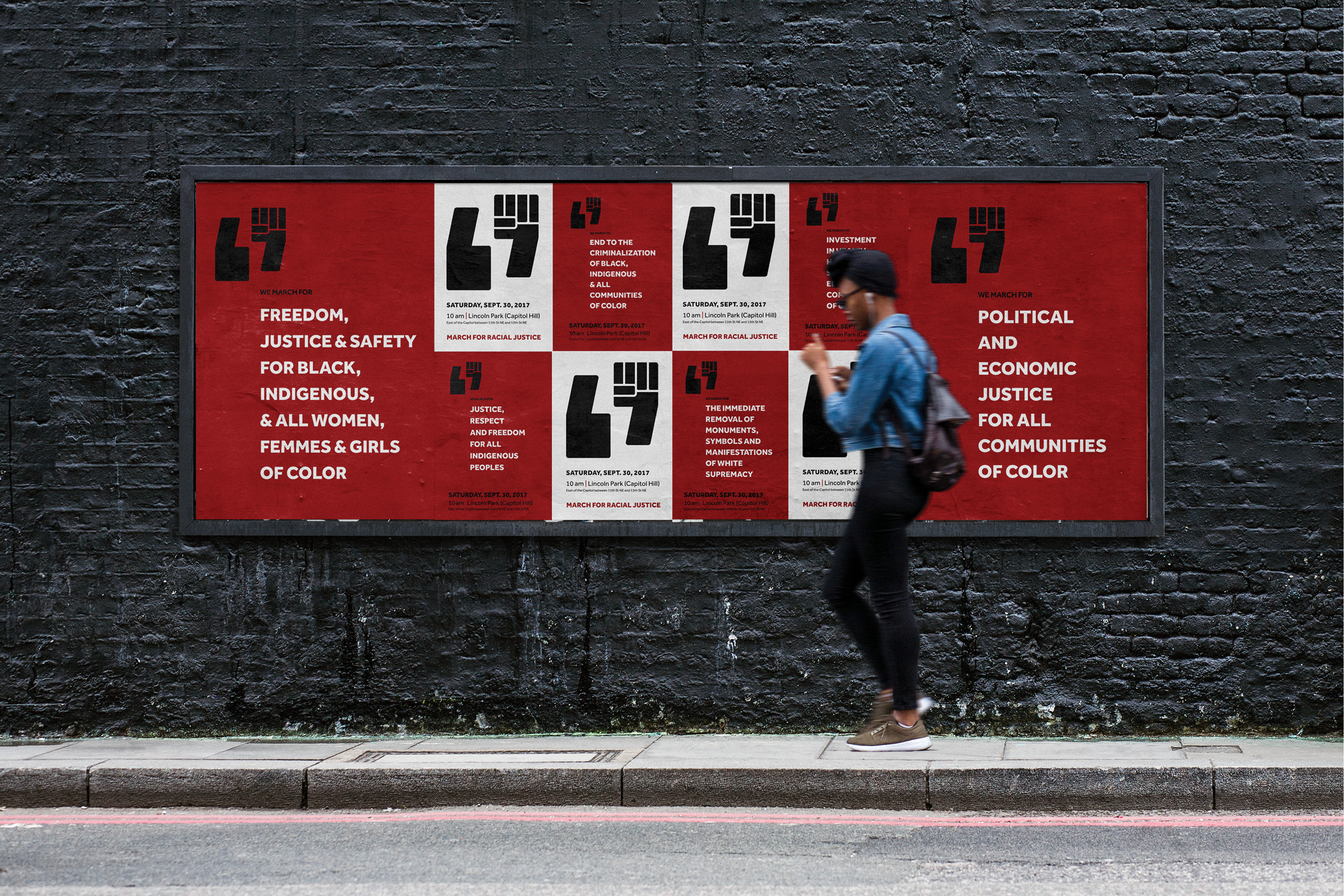 A woman walking in front of a series of promotional wheat-pasted posters for the March for Racial Justice. The posters alternate red and and white, announcing the date and time and the founding principles of the organizers.